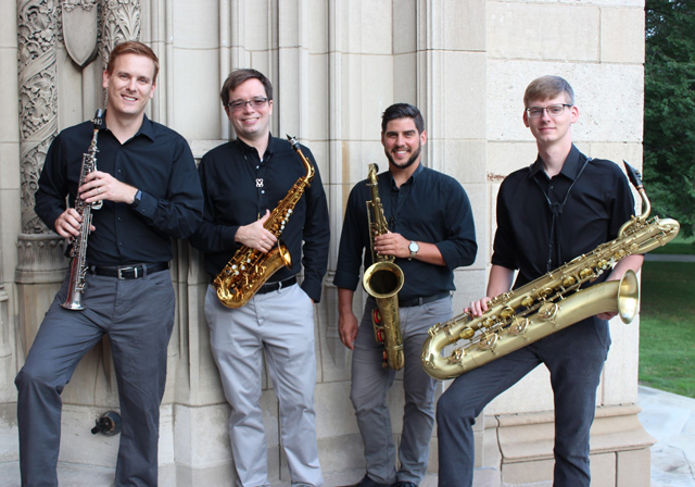 Members of the Bridges Saxophone Quartet pose holding instruments on a staircase.