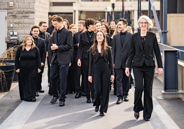 Students in a choir walking on campus.