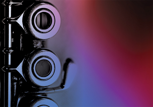 A closeup photo of a flute with a swirled translucent red and blue color overlay..
