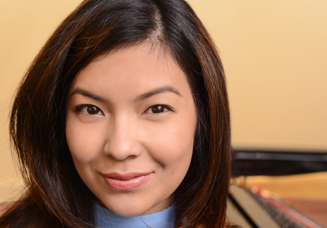 Headshot of Melody Quah in front of a piano.