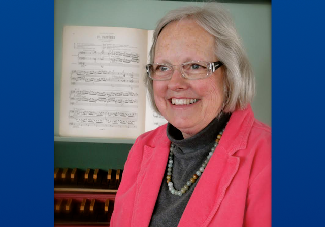 Susan Ferré sits in front of an organ.