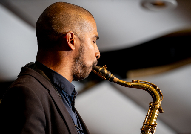 A man plays a saxophone.