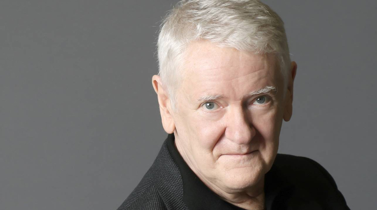 Jim Anderson poses for a headshot in front of a gray background.