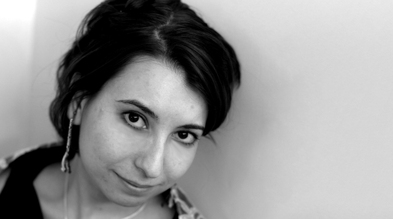 Bonnie Bogovich poses for a headshot in front of a gray background.