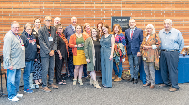 Posed group shot of alumni at a Homecoming event.