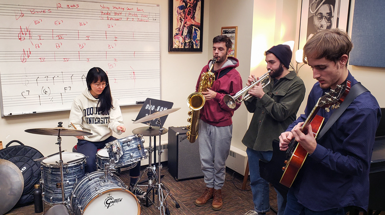 Students play instrument in a teaching studio.