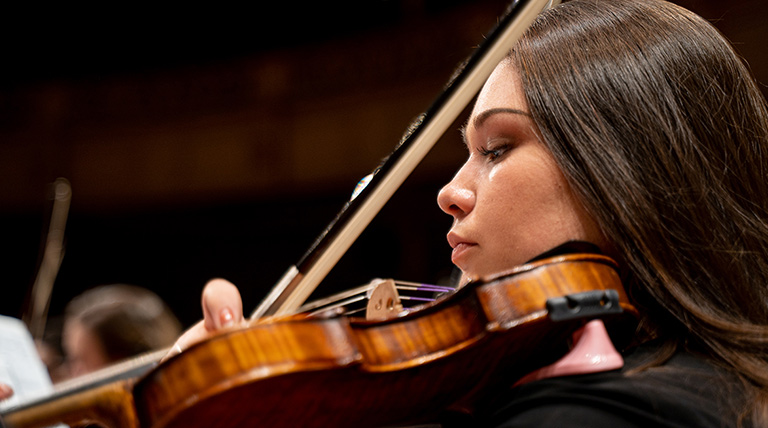 A woman plays violin.