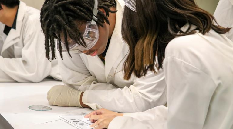 girl holding up dna fingerprints