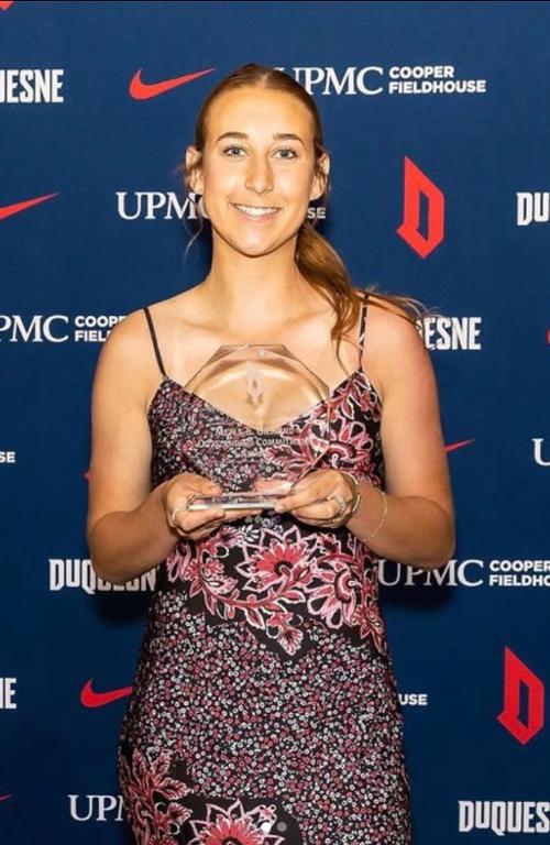 a girl holding a trophy