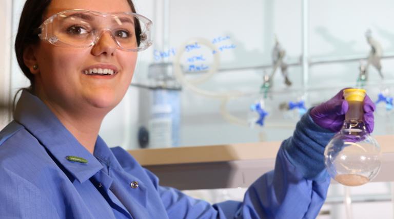 two girls holding beakers