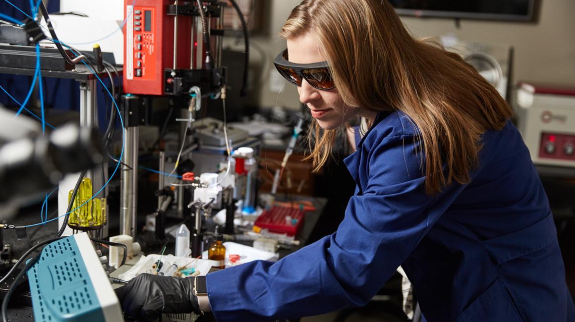 a female working in engineering lab. 