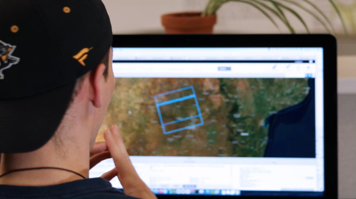 a boy looking at a computer screen