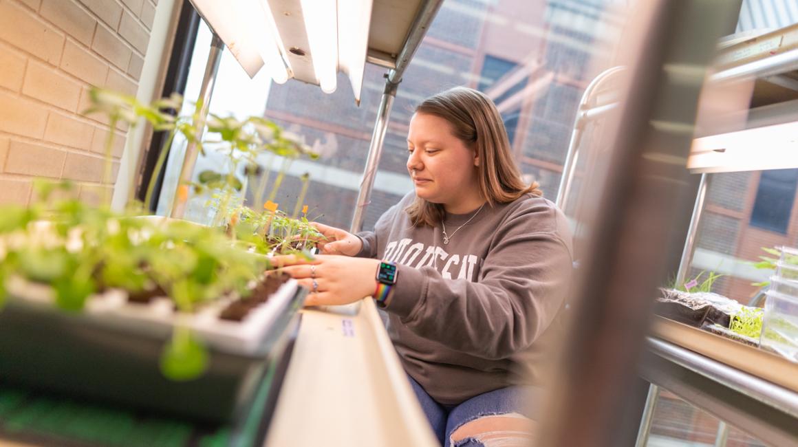 a picture of a girl with a plant