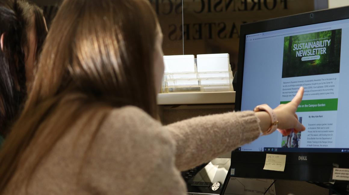 girls looking at a computer screen