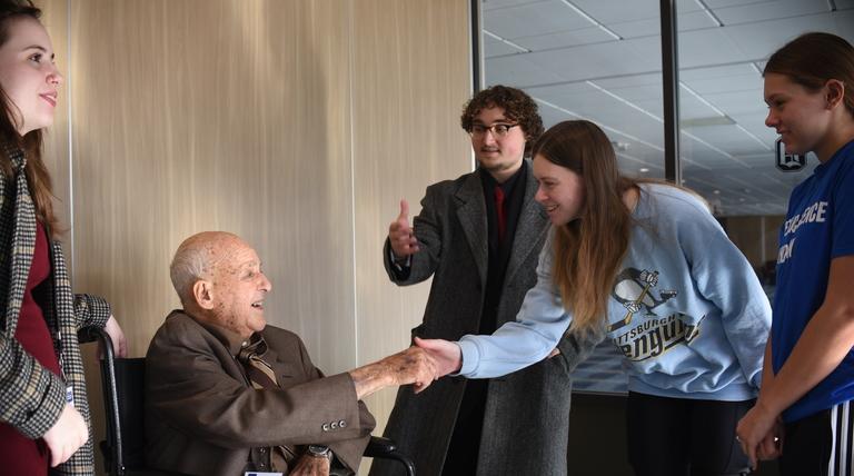 cyril wecht shaking hands with students