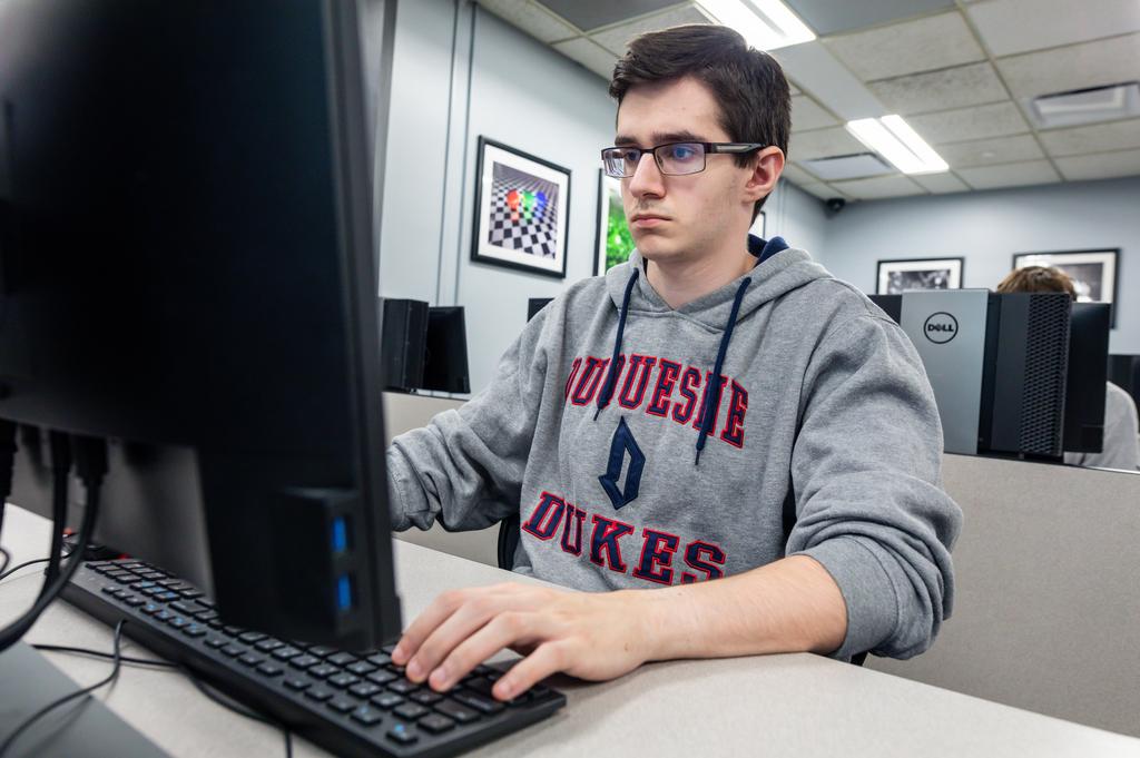 A picture of a boy at a computer 