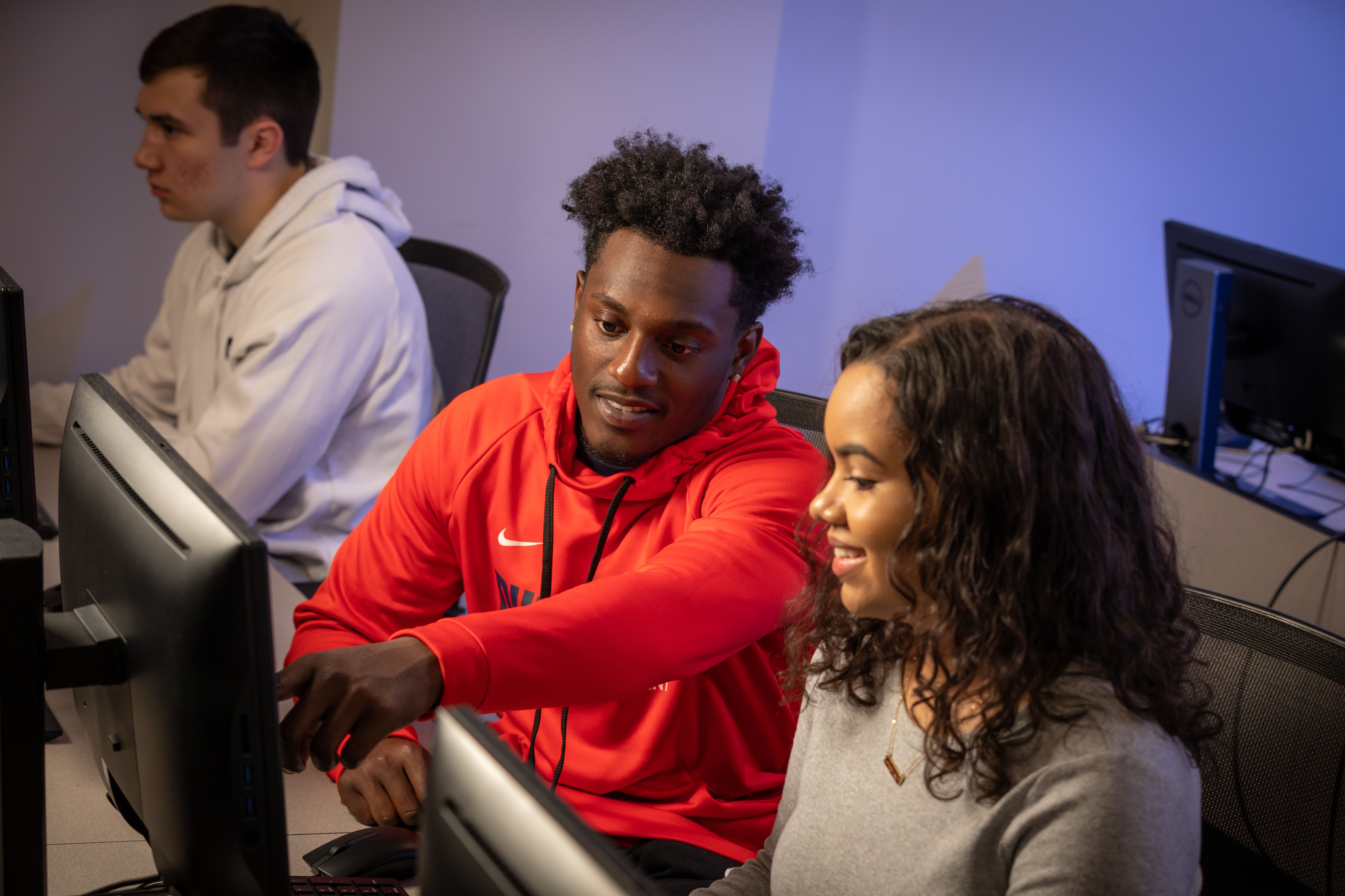 A picture of students looking at a computer