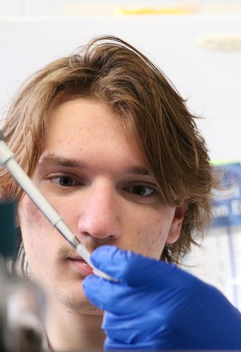 Justin Singer holding a pipette