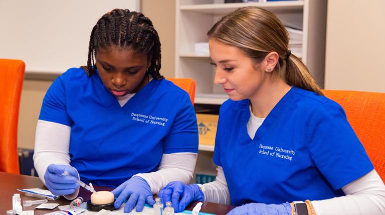 Two nursing students in the skills lab