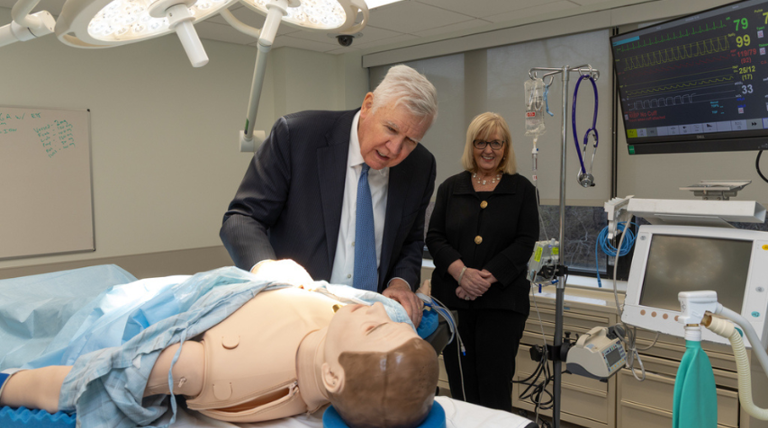 Bill Conway in the OR room with Dean Mary Ellen Smith Glasgow.