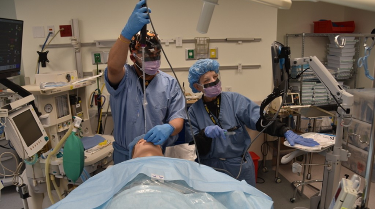 nursing teacher and student going over an anesthesia procedure
