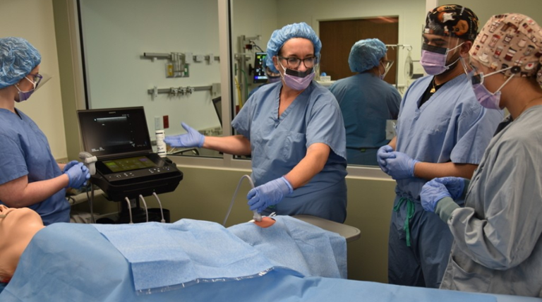 nurse working with students on anesthesia