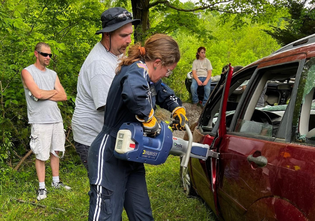 nurse using jaws of life on an suv