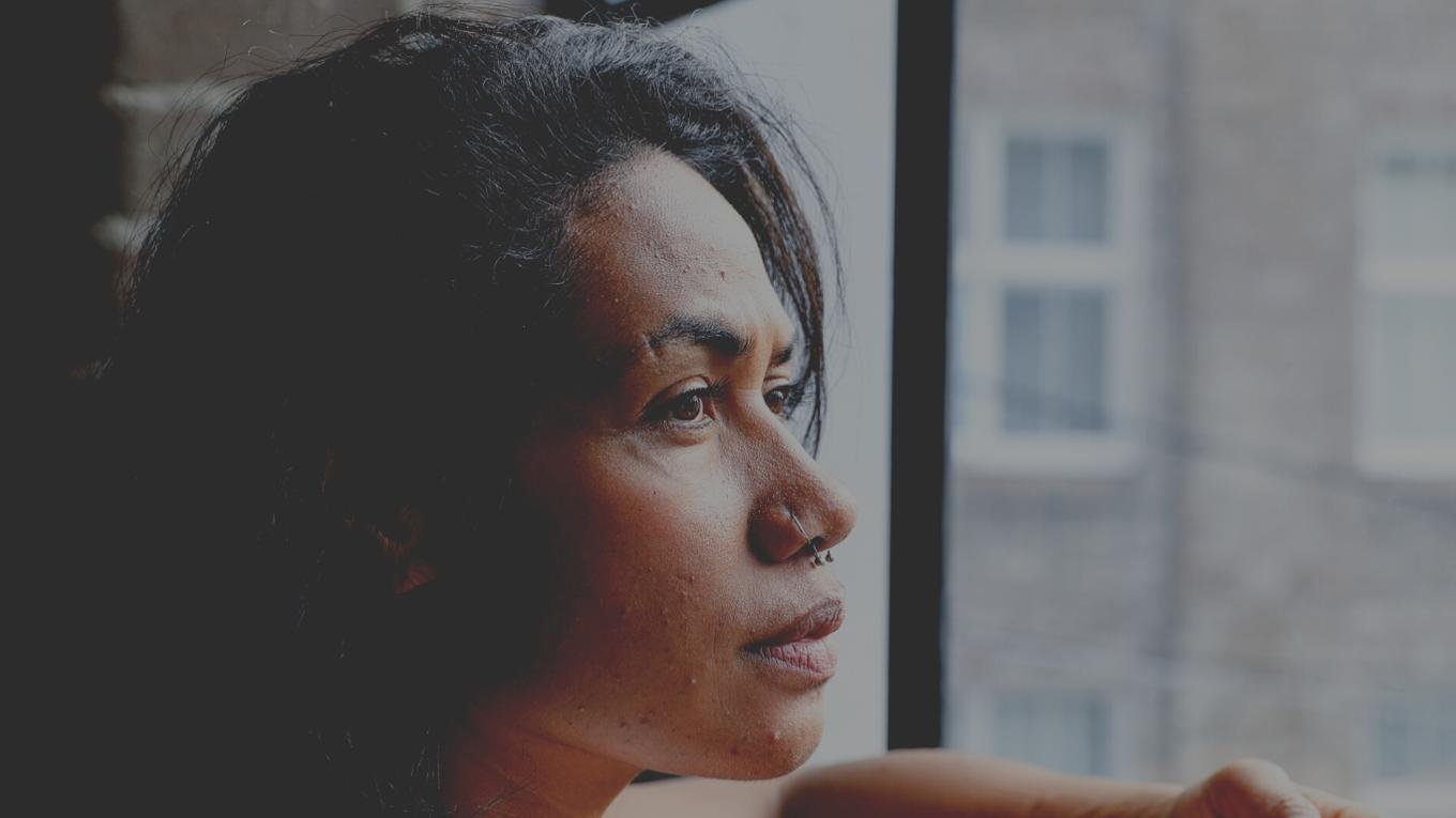 woman looking out a window