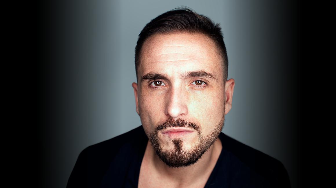 hispanic man looking at camera