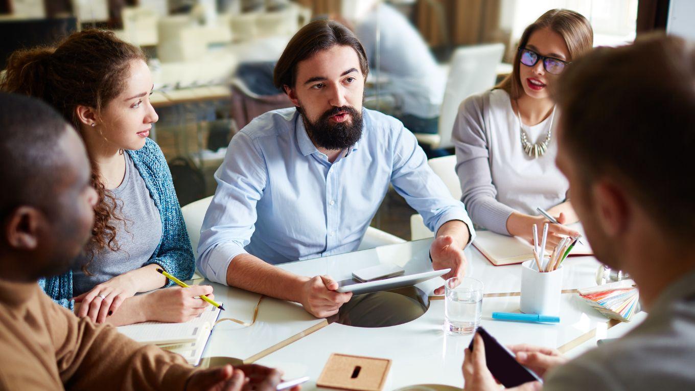 Professor discussing with students at table