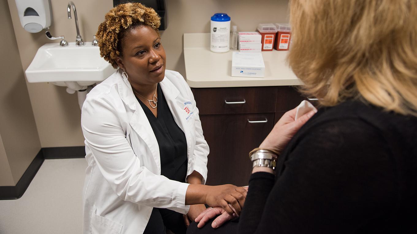 Black nurse talking with female