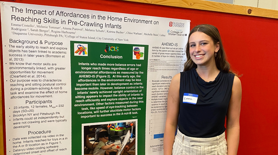 Nursing Student standing next to thier research posters
