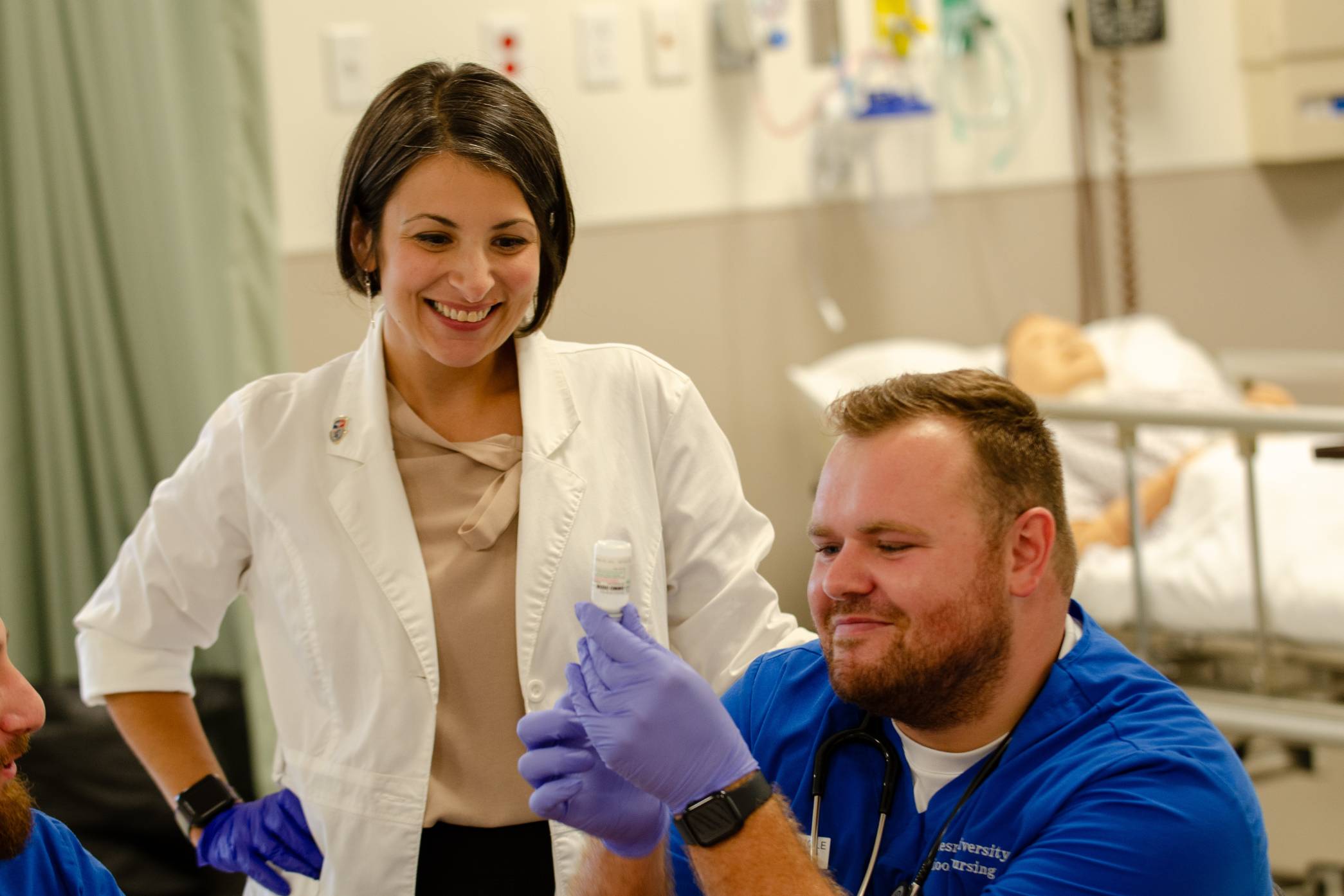 male student with professor in lab