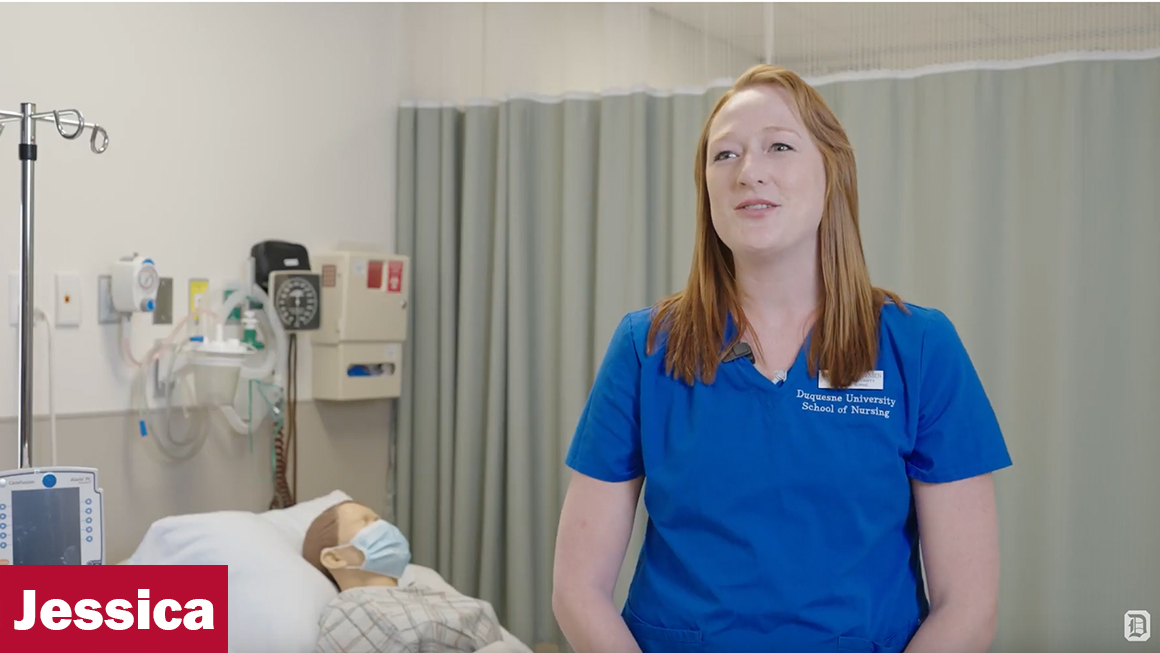 Jessica dressed in scrubs in the lab