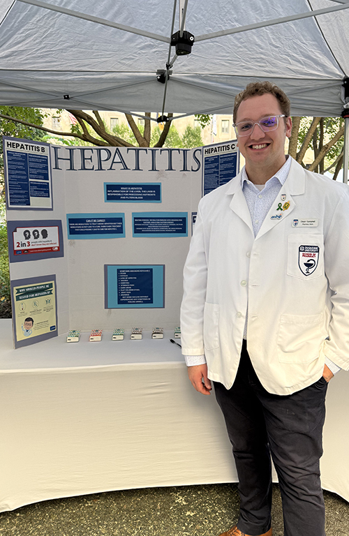 owen campbell at the health fair with his poster