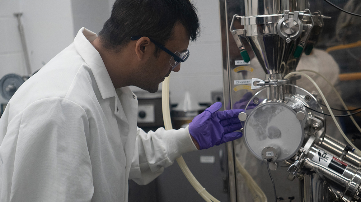 a ph.d. student conducting research in a pharmaceutics lab