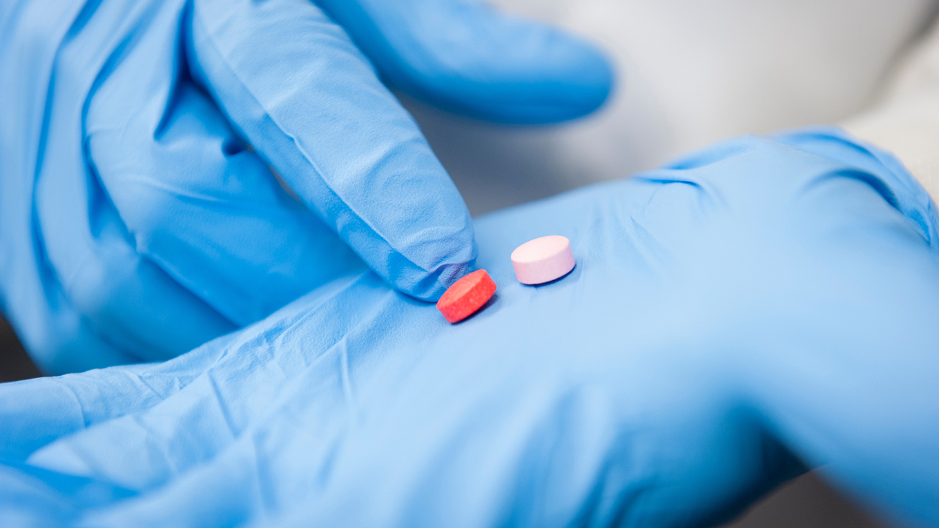 Pills in gloved hand