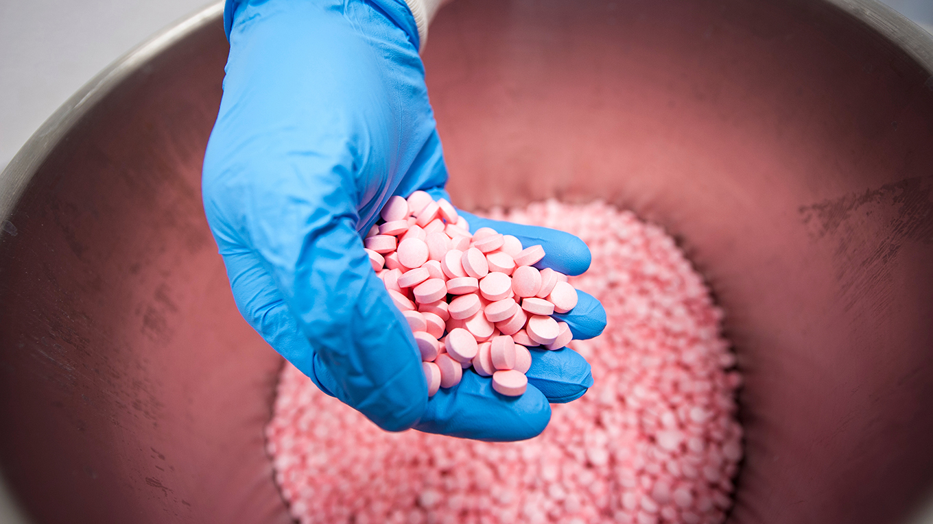 Pills in hand in lab