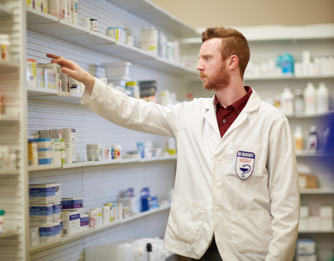 Student Stocking shelves in a pharmacy