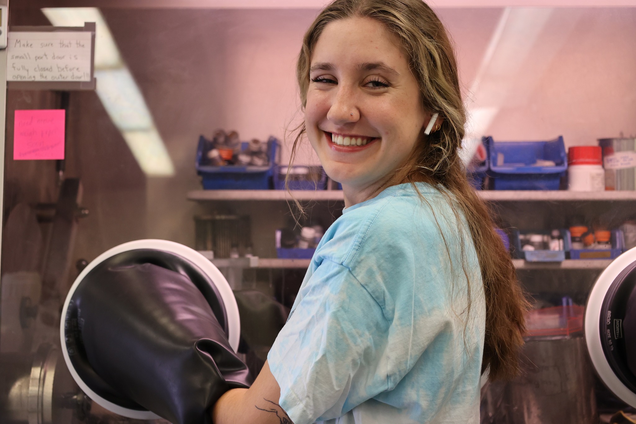 A picture of a girl in a glovebox, smiling