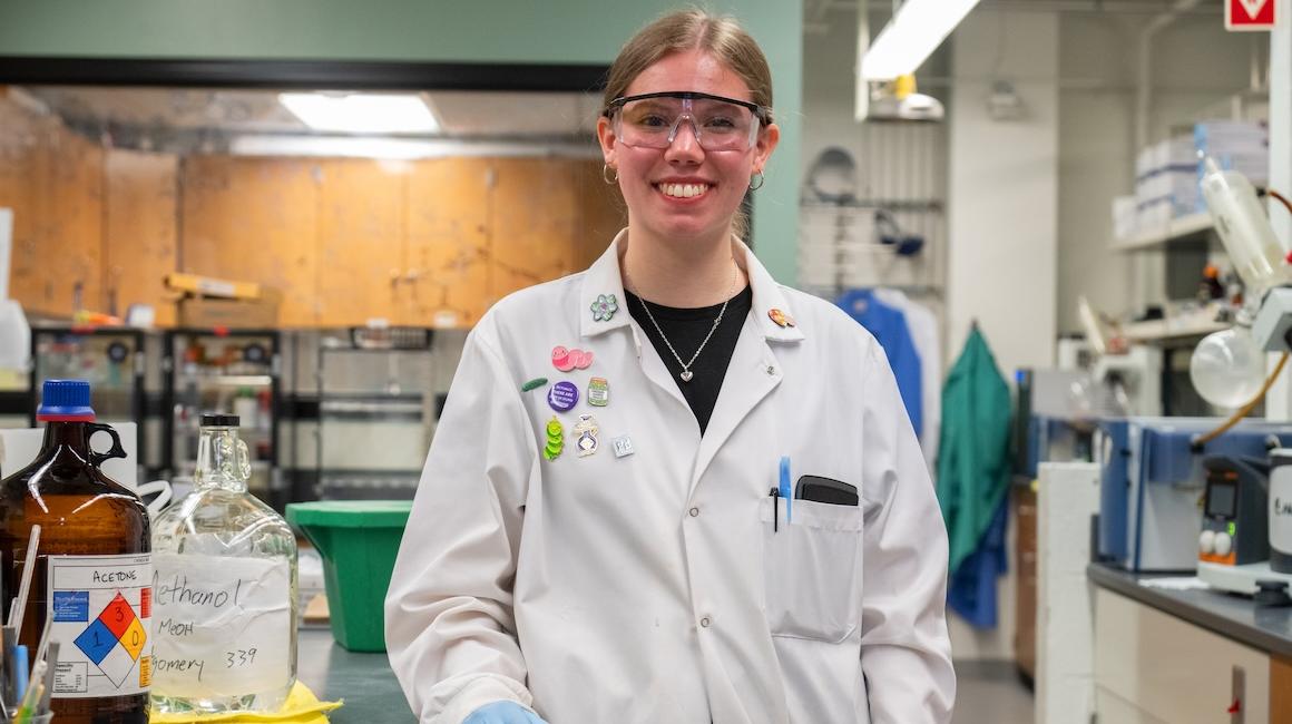 a girl in a white jacket and goggles