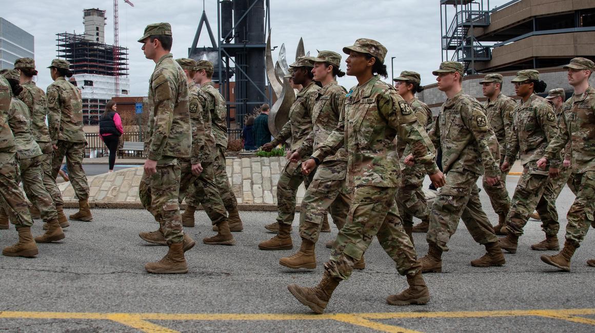 students in military uniforms marching
