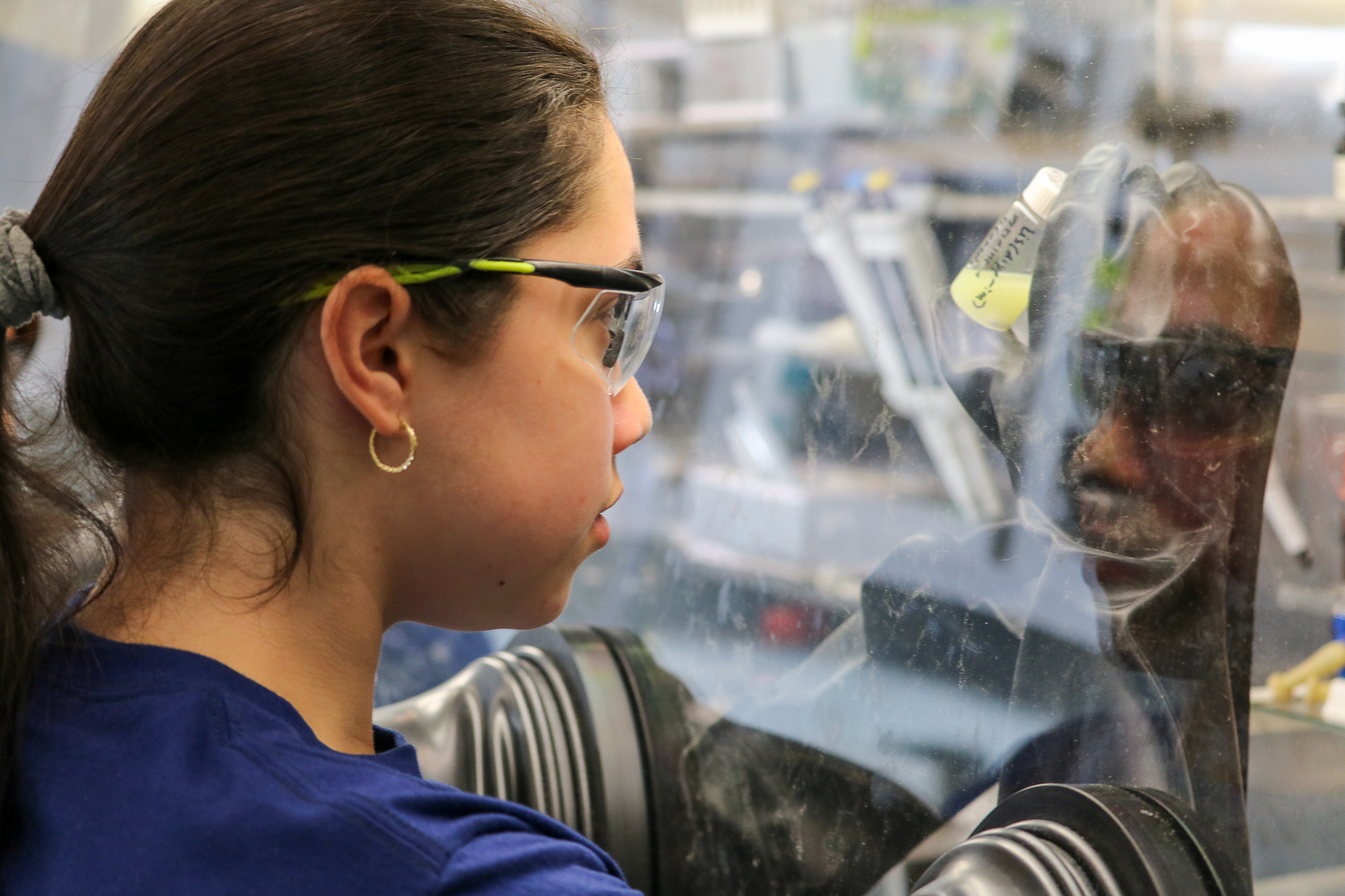 girl looking into a microscope