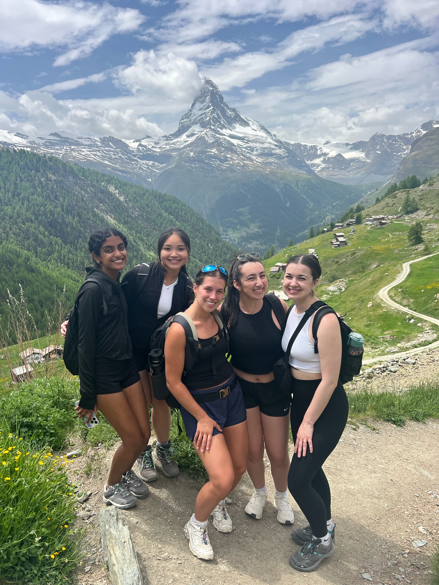 five females in front of mountains