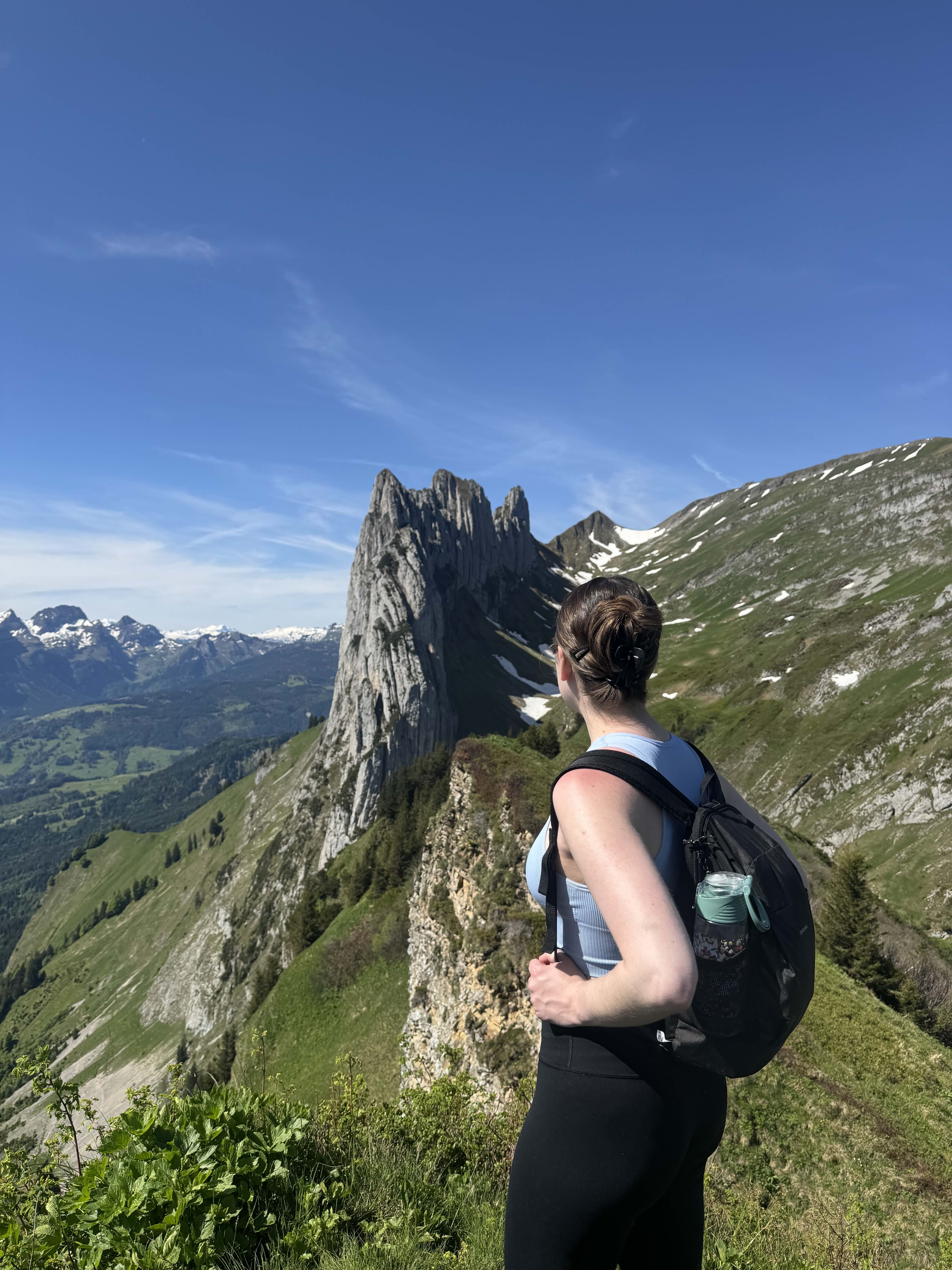 a girl in front of a mountain
