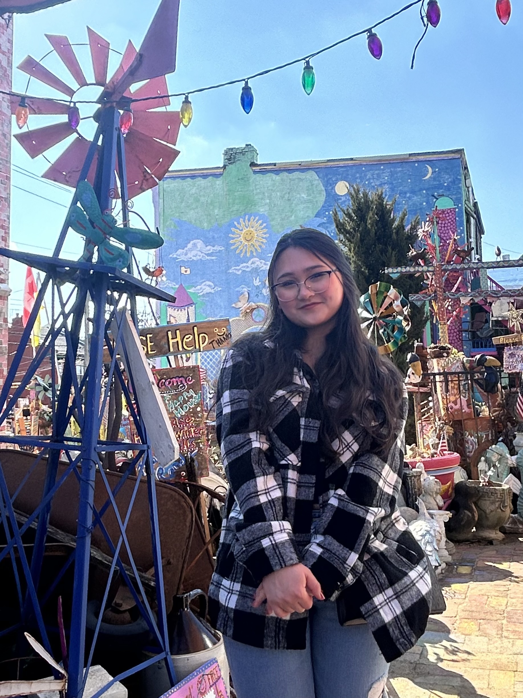a girl in a plaid shirt behind lights