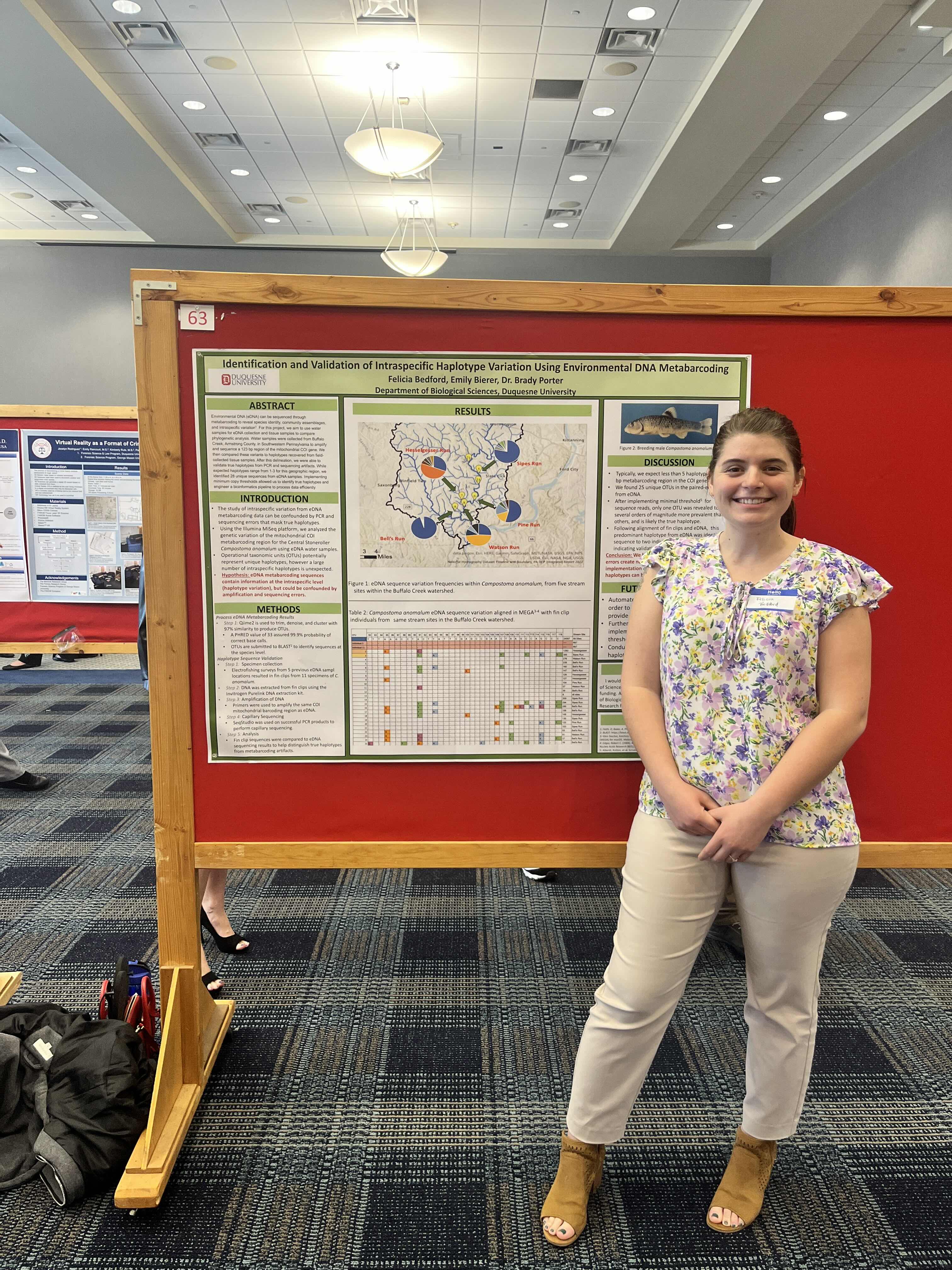 a girl in front of a research poster