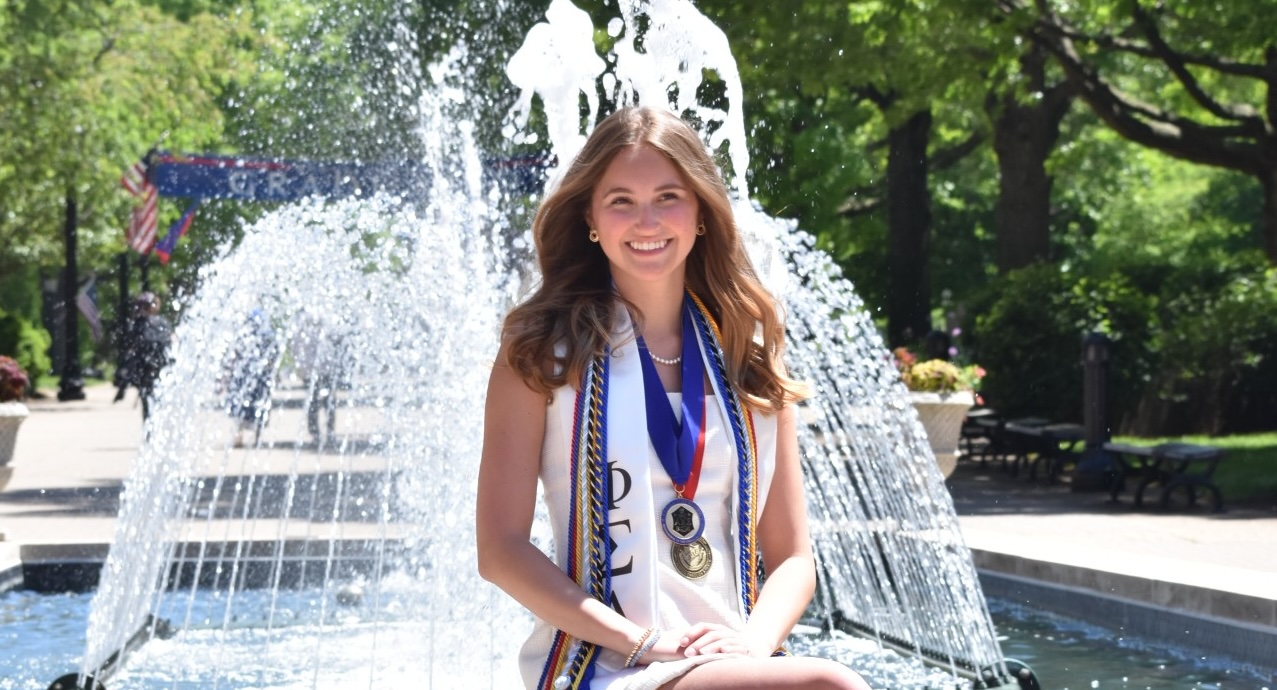 a girl in front of a fountain