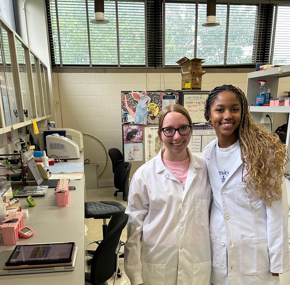 A photo of two girls in white coats.