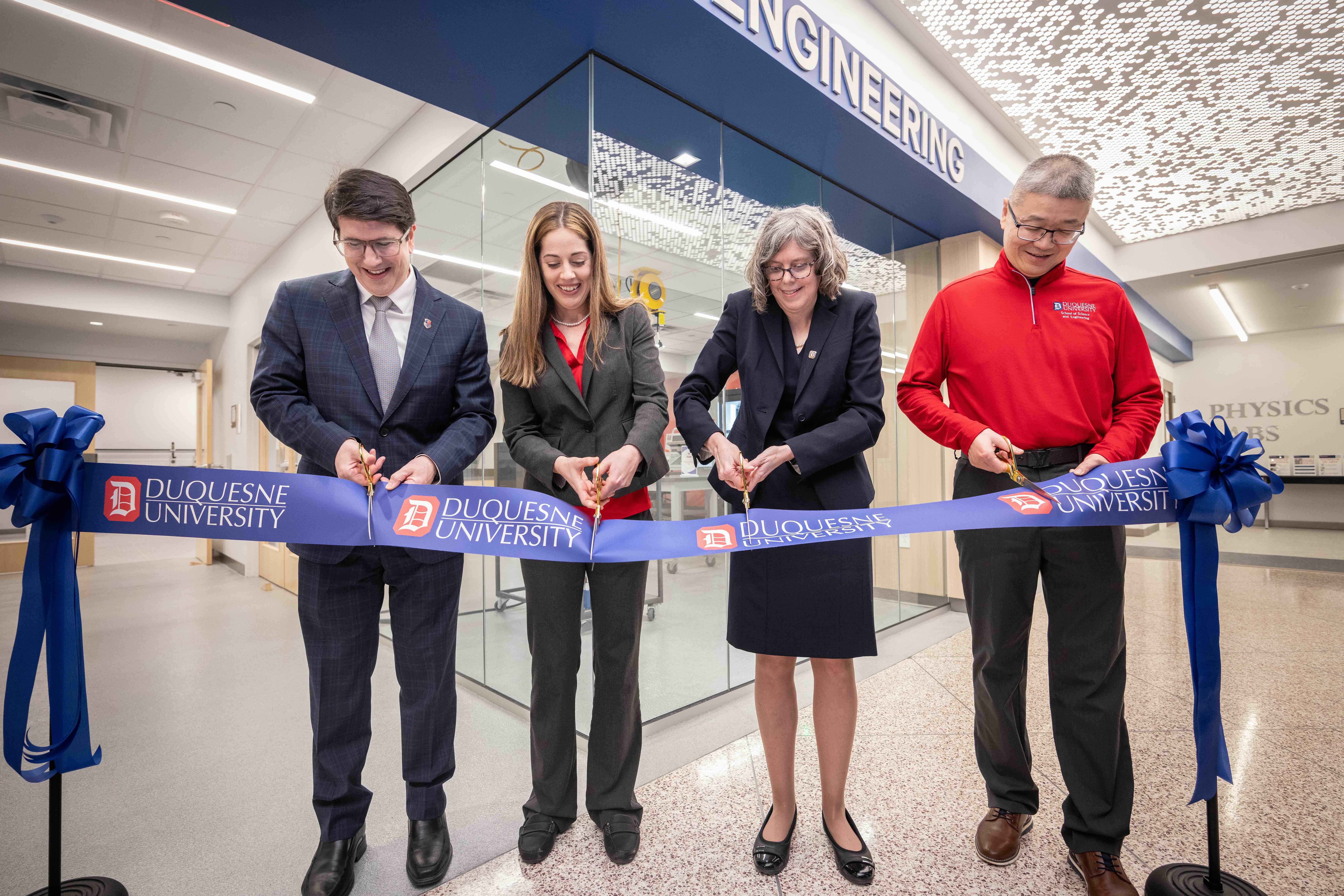 people cutting a ribbon